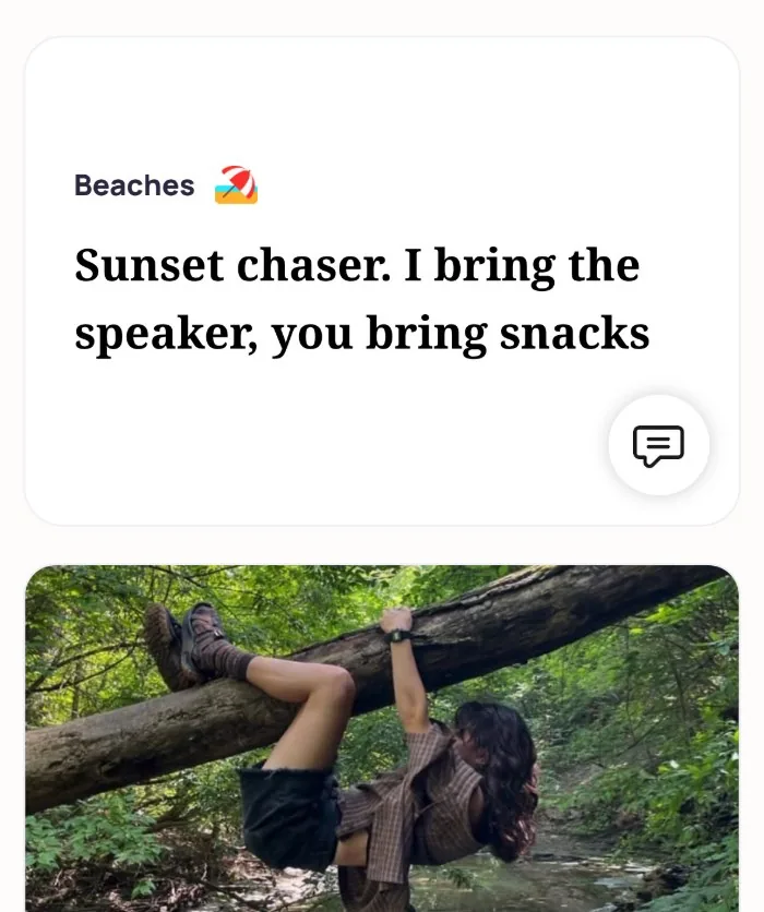 An Alyke profile card for Beaches that reads: Sunset chaser. I bring the speaker, you bring snacks, above a photo of someone hanging from a fallen tree over a creek