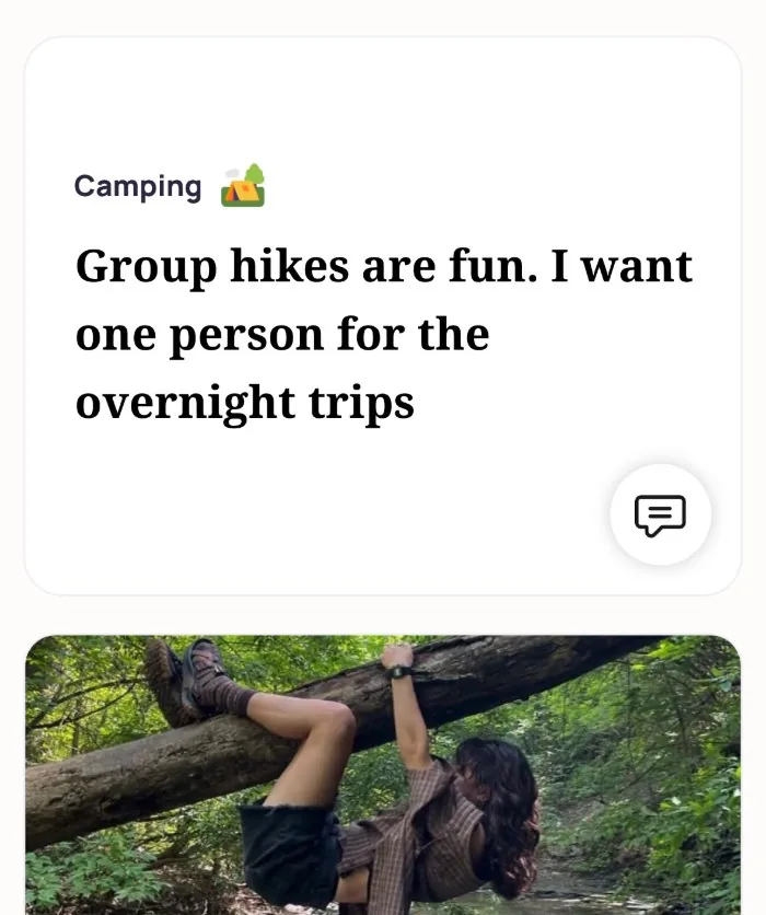 An Alyke profile card for Camping that reads: Group hikes are fun. I want one person for the overnight trips, above a photo of the member hanging from a fallen tree over a forest creek