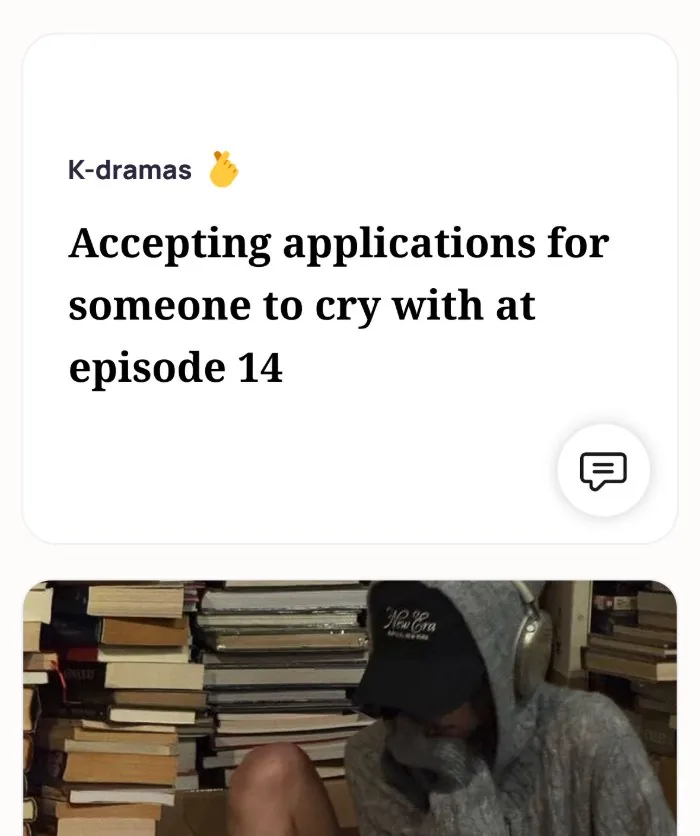 An Alyke profile card for K-dramas that reads: Accepting applications for someone to cry with at episode 14, above a photo of the member in a cap and hoodie among stacks of books