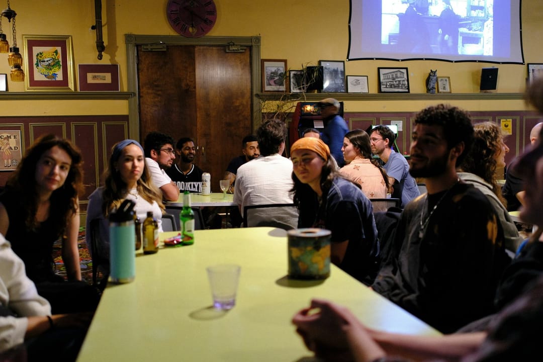 Eight people at a bar trivia night split into two separate conversations