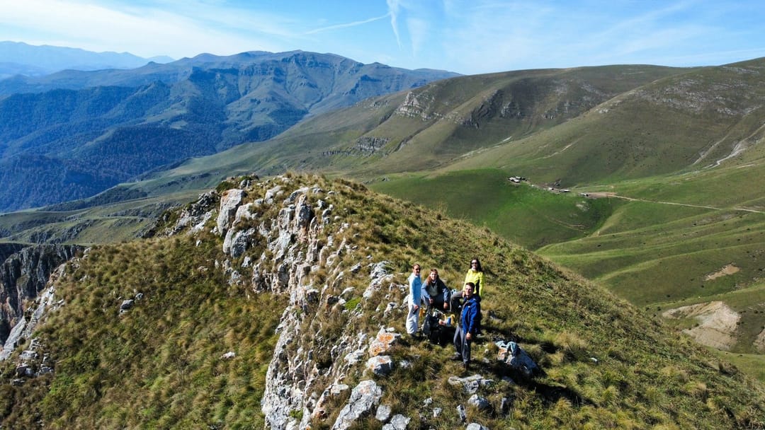 Hikers talking on a foggy coastal ridge