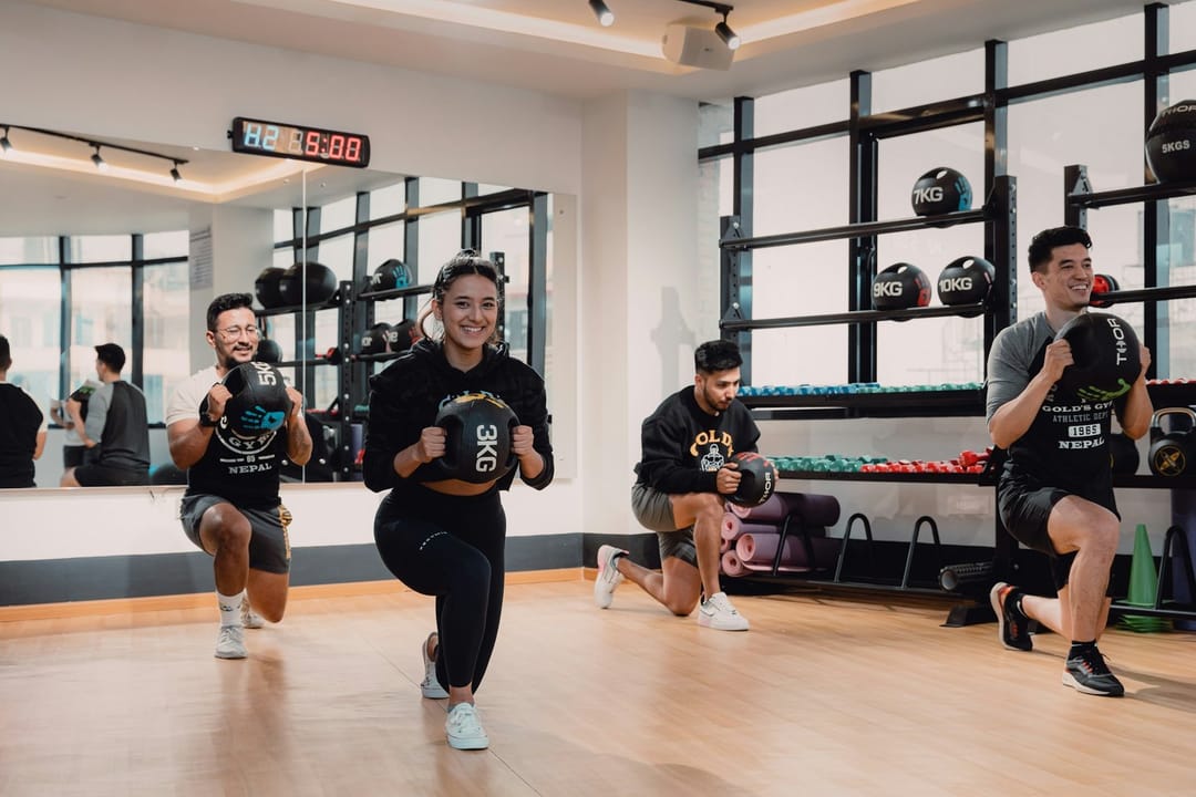 People in a group strength class at a gym