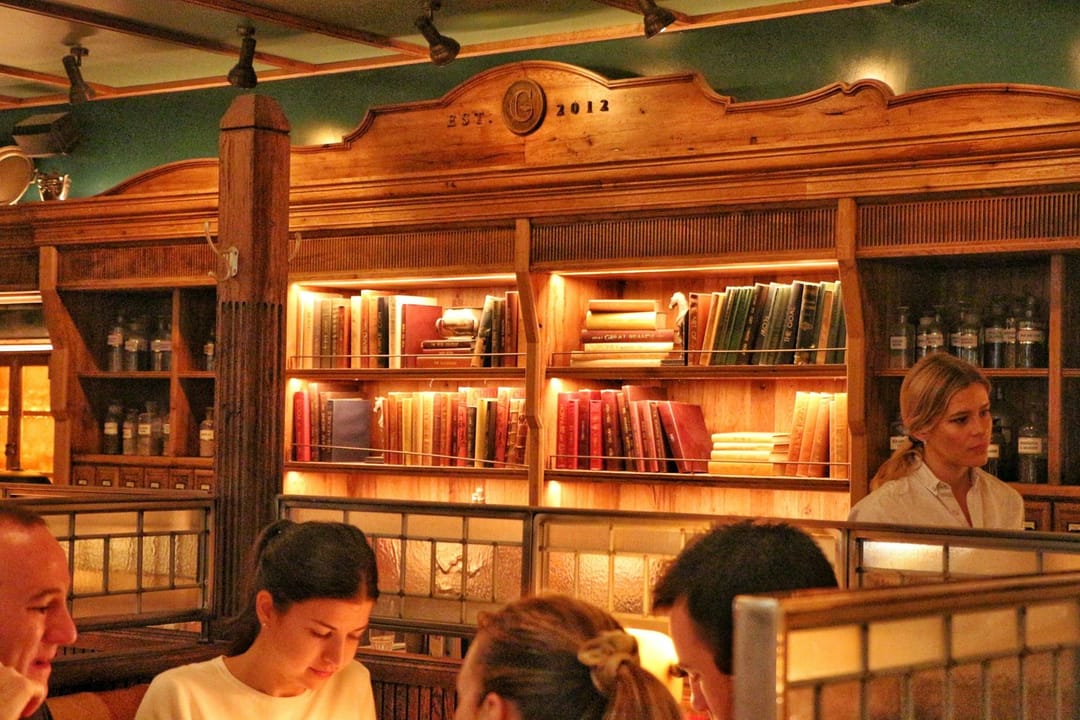 People reading together at a Silent Book Club meeting in a bar