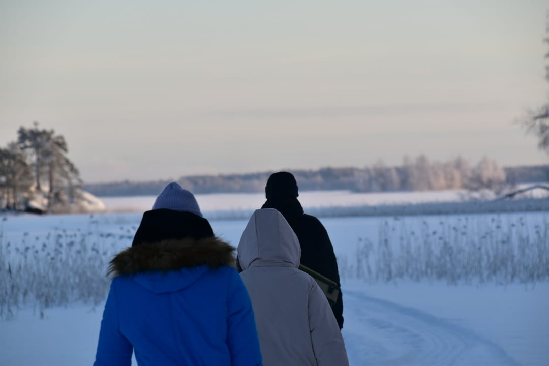 Two friends with coffee on the Lakefront Trail in winter