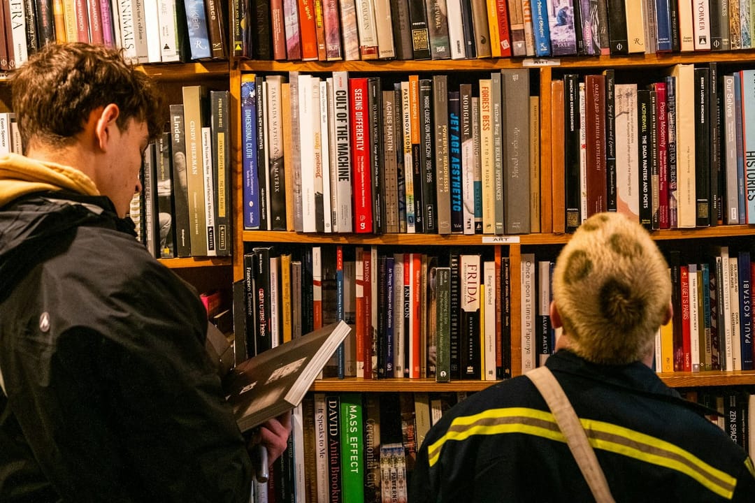 Two people talking in a bookstore signing line