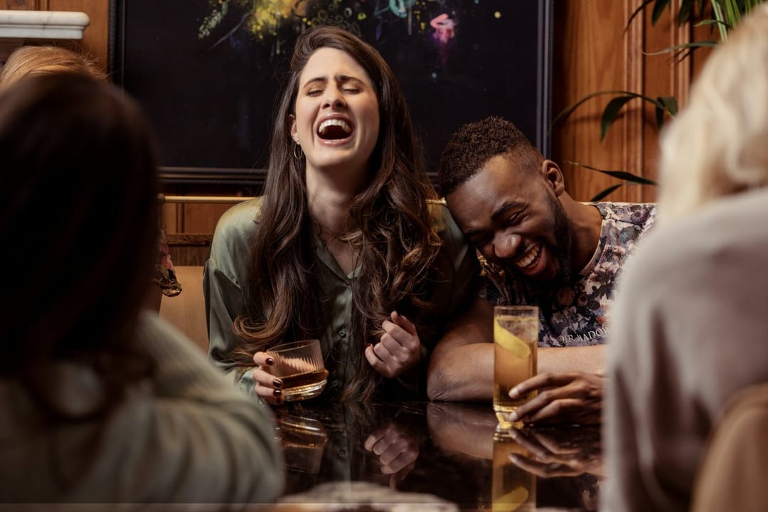 Two regulars laughing at a brunch counter
