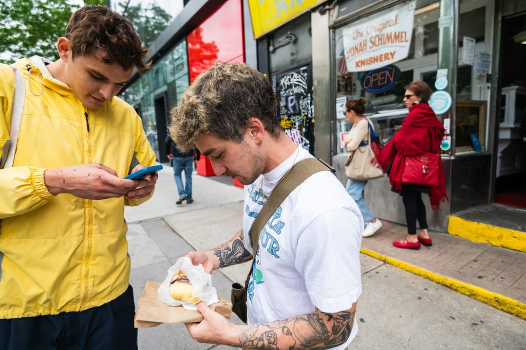 Two runners sharing a pastry after a Saturday run