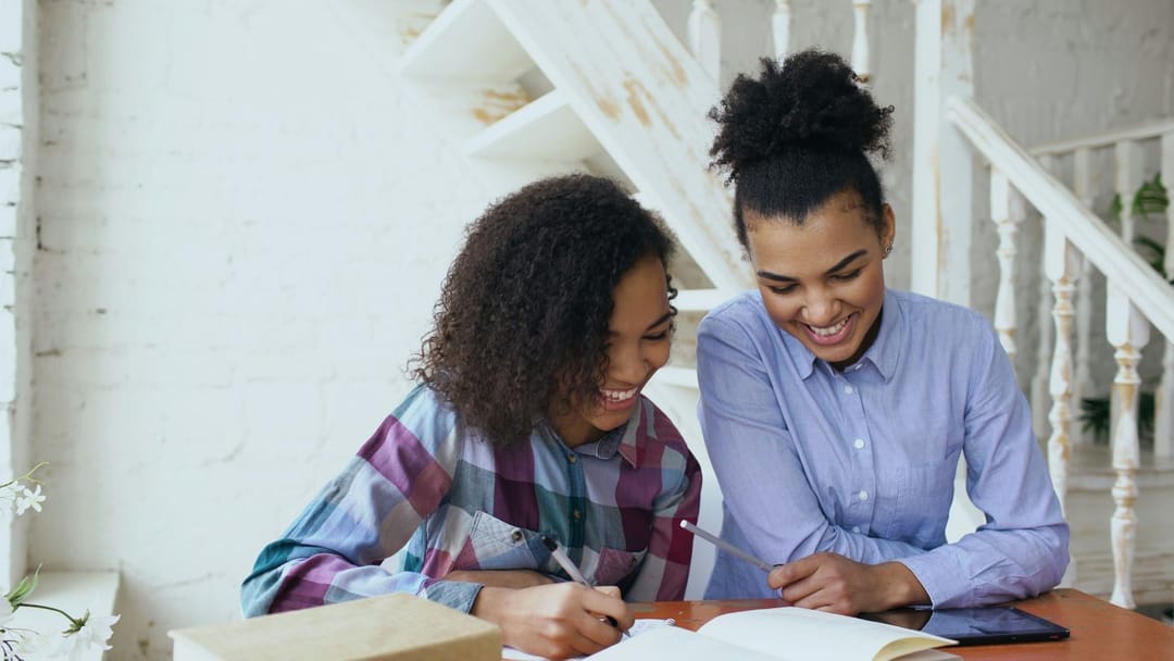 Two students sharing a textbook in a Korean class
