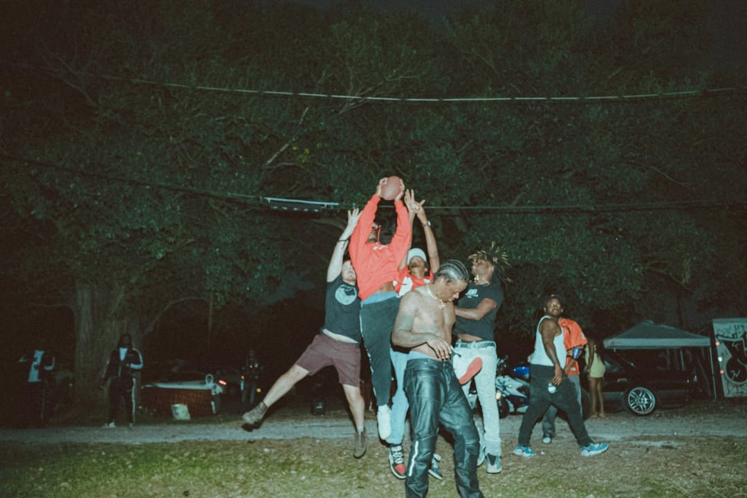 Ultimate frisbee players on a floodlit field at night