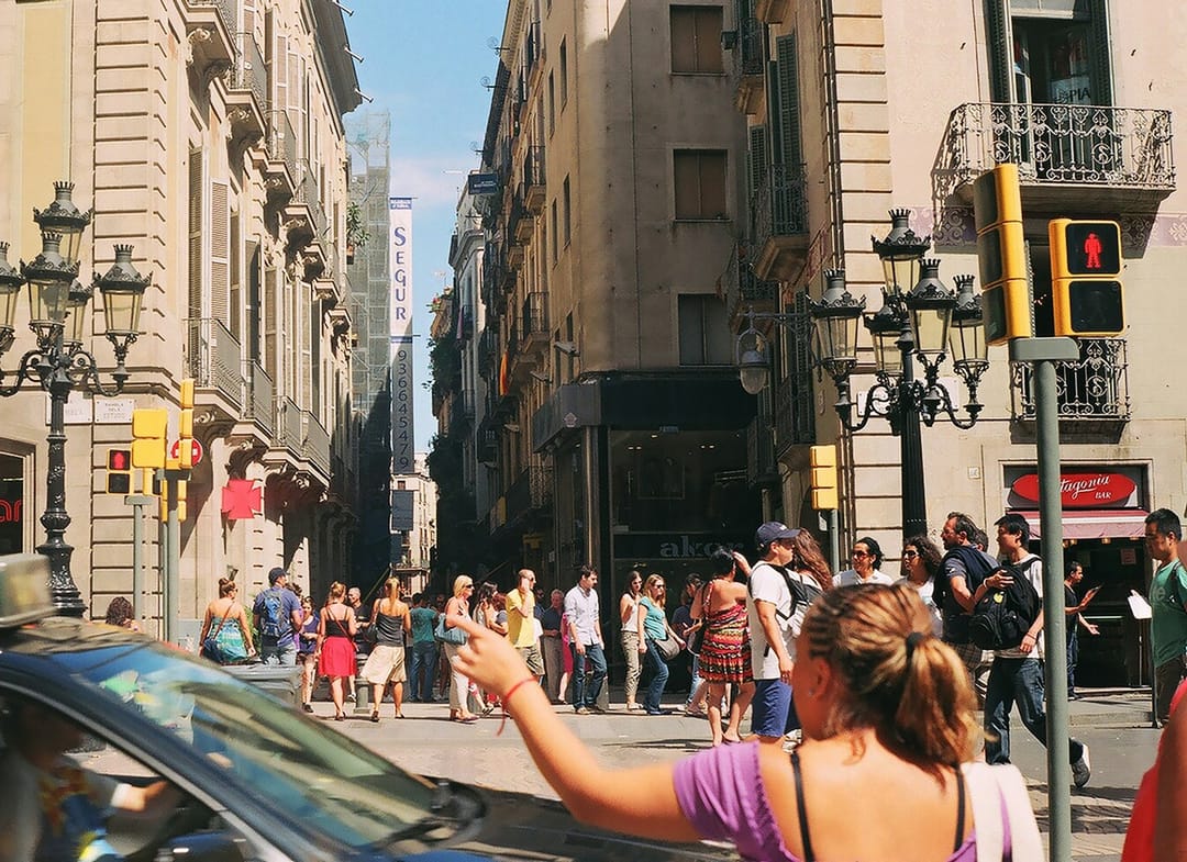 A volunteer showing hostel guests around a city square