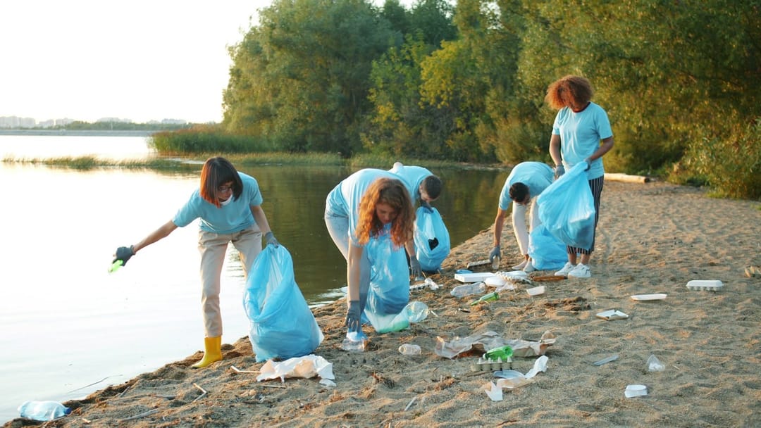 Volunteers passing bags of oyster shell along the shoreline
