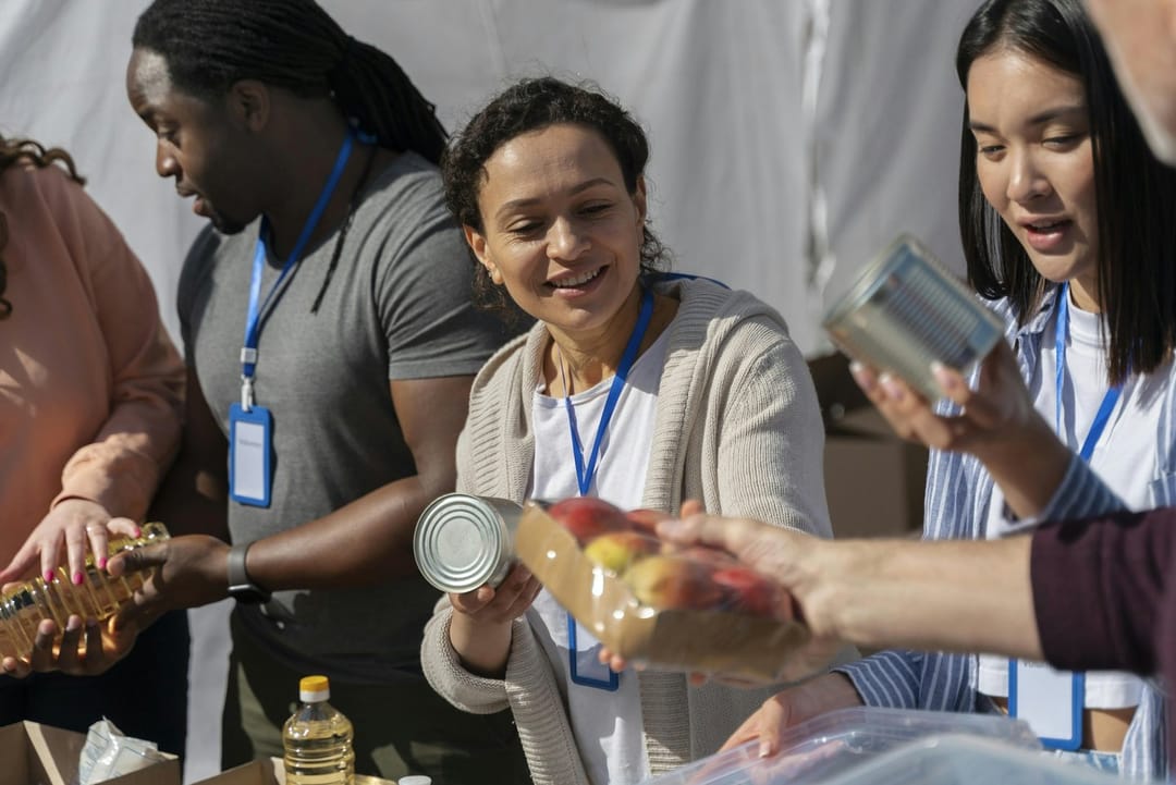 Volunteers sorting cans on a food bank line